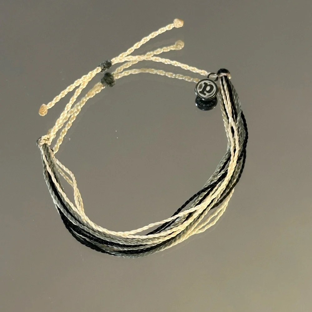 Pura Vida. Black and Cream Multistrand Braided Bracelet with Silver Charm